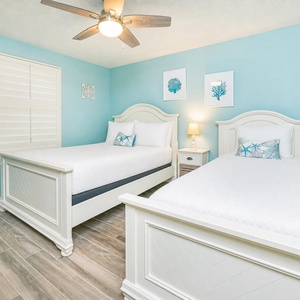 Guest suite with a double and a twin bed invites restful nights surrounded by calming blue walls