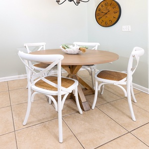 Gather around the round dining table with stylish white chairs, perfect for meals or games during your stay