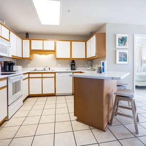Cook and gather in this spacious kitchen, featuring ample counter space, breakfast bar, and coffee station