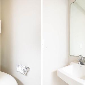 Additional half bath featuring soft towels, a sleek sink, and decorative wall art for a pleasant experience