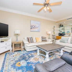 Relax in the cozy living room, enjoying conversations while the gentle breeze flows through the balcony doors