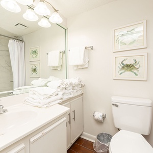 Refresh and rejuvenate in the guest bathroom, where soft towels await after your beach adventures