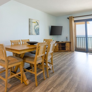 Living space featuring a dining table, flat-screen TV, and breathtaking views from the balcony