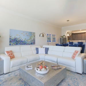 Settle into the sectional and take in the vibrant fish painting above for relaxation after a day at the beach