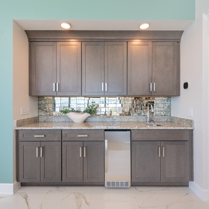 Enjoy preparing drinks and snacks at the stylish wet bar with sleek cabinetry and beautiful granite countertops