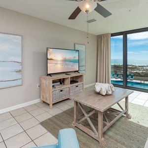 Enjoy the spacious living area with a large TV, inviting decor, and stunning views through expansive windows