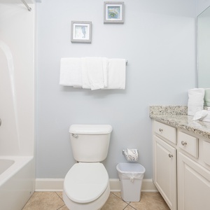 Freshen up in this guest bath in the relaxing shower or soothing tub before an exciting beach day