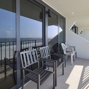 Relax on the balcony with seating and enjoy breathtaking beachfront views