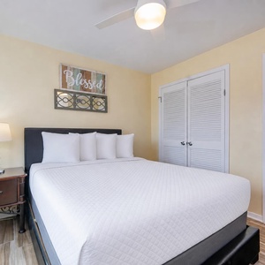 Soft white pillows and warm hues invite you to unwind on the queen bed in the master suite
