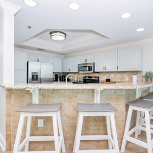 Enjoy casual meals at the sleek bar with comfortable seating, perfect for gathering and sharing stories