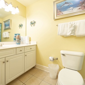 Refresh in the cheerful guest bathroom featuring a double vanity, vibrant decor, and a spacious tub/shower area