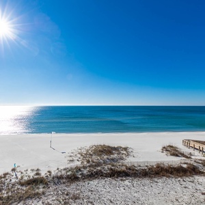 Gaze at the sparkling waters and soft sand, perfect for relaxing beach days and refreshing gulf breezes