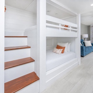 The kids will snuggle in for the night in this bunk area with cozy twin over twin bunks