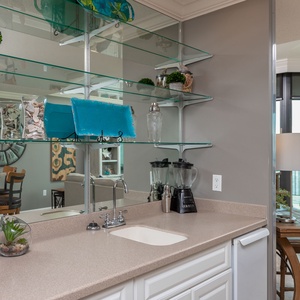 Mix refreshing drinks at the wet bar, perfect for unwinding with loved ones after a fun day at the beach