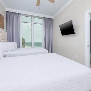 Wake to a breathtaking sunrise in this queen guest suite with two cozy beds and expansive views from the windows