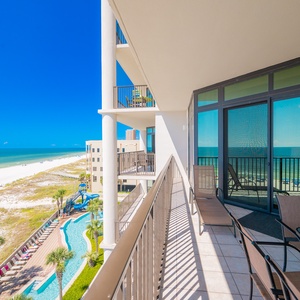 Enjoy expansive views from the spacious balcony overlooking the beach and lazy river, perfect for relaxation