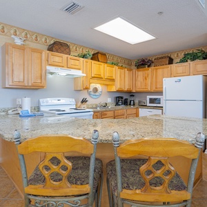 Gather around the kitchen, enjoying meals and conversation in this welcoming space with ample seating