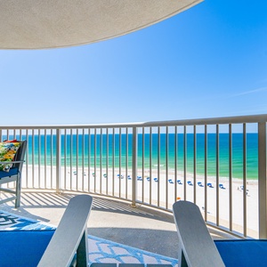 Relax on the balcony in comfortable chairs, enjoying breathtaking beachfront views and a serene atmosphere