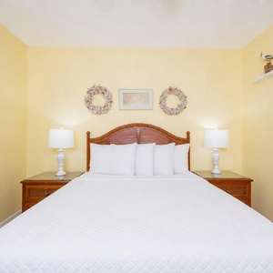 Drift into restful slumber on the plush king bedding, surrounded by warm hues and beach-inspired decor