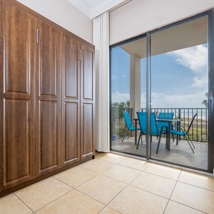 Living space featuring a wall-mounted fold-down full murphy bed for convenience of additional guests