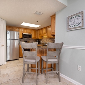 Gather around the breakfast bar with two stools, perfect for casual meals in this inviting kitchen space