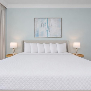 Rest peacefully in the master suite featuring a large king bed, soft linens, and calming coastal decor