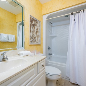 Freshen up in this guest bath in the relaxing shower or soothing tub before an exciting beach day