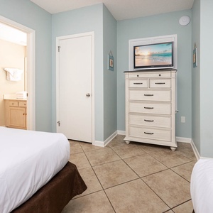 Inviting guest room featuring two double beds, a TV, and cheerful decor that enhances your stay