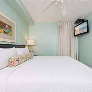 Fluffy pillows invite you to relax in the king suite for a calm movie night after a fun day at the beach