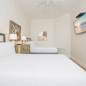 Enjoy restful nights in this spacious guest bedroom, where soft queen bedding invites family to recharge after a beach day
