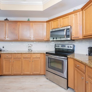 Bright modern kitchen featuring stainless appliances, granite countertops, and ample cabinetry for a delightful experience