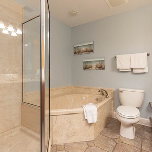 Indulge in relaxation with a spacious jetted tub and a separate walk-in shower, complemented by soothing décor