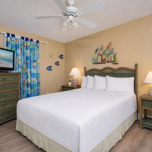 Drift into a peaceful sleep in this queen guest suite surrounded by charming coastal decor and soft, inviting bedding