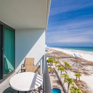 Quiet moments await on your balcony where you watch beachgoers stroll under a clear blue sky