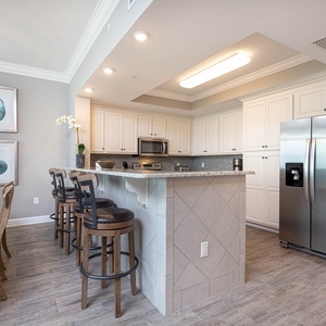 Sip your morning coffee at the breakfast bar and get ready for a beach day in this stylish space
