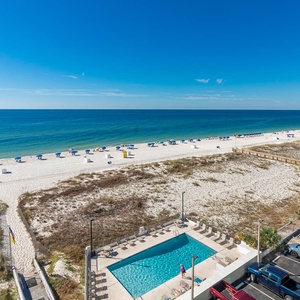Enjoy stunning beachfront views from this inviting space, complete with a pool for relaxation and fun