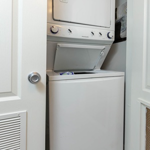 This laundry area features a stacked washer and dryer, providing convenience for your vacation stay