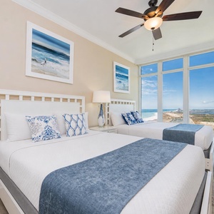Two queen beds in the guest suite invite restful nights while you enjoy endless coast views beyond the windows