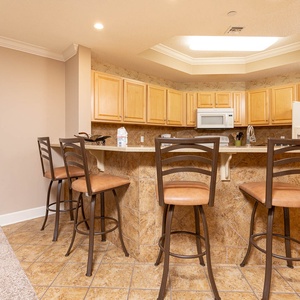 Sip your morning coffee at the breakfast bar and get ready for a beach day in this stylish space