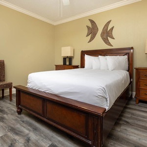 Retreat to this guest bedroom featuring a queen bed, stylish decor, and a comfortable chair for reading or relaxation