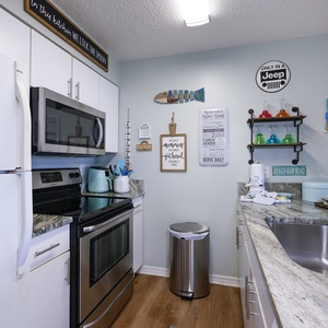 This kitchen features stainless appliances, granite countertops, and cheerful decor, making meal prep a delight