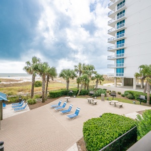 Relax under the gazebo or lounge by the pool, enjoying the lush greenery and easy access to the beach