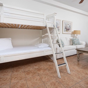 Relax in the living space featuring a twin bunk bed, comfortable seating, and charming decor for a delightful stay