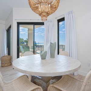 Dine at the round table with a view of the pool, surrounded by natural light from large sliding doors