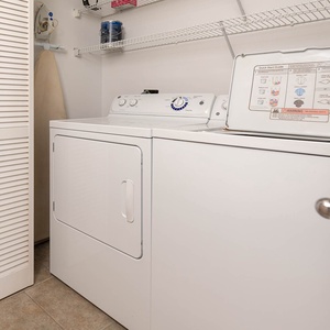 Laundry area featuring a washer and dryer, with a closet for storage and a shelf for additional supplies
