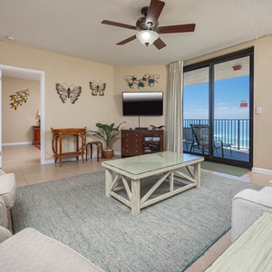 Unwind in the inviting living area, featuring comfortable seating and beachfront views through large sliding doors