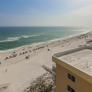 Experience breathtaking views from the balcony overlooking the sandy beach, perfect for relaxation and fun in the sun