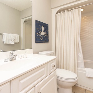 Refresh yourself in this guest bath, where soothing decor and ample space brighten up your routine