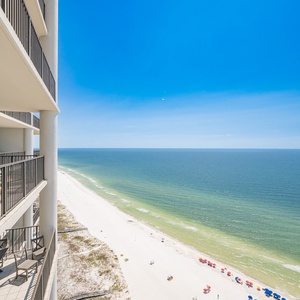 Stunning views of the pristine beach and vibrant umbrellas from the spacious balcony invite relaxation and enjoyment