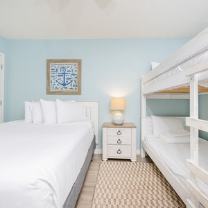 Guest bedroom featuring a cozy full bed, a twin bunk bed, and charming coastal decor